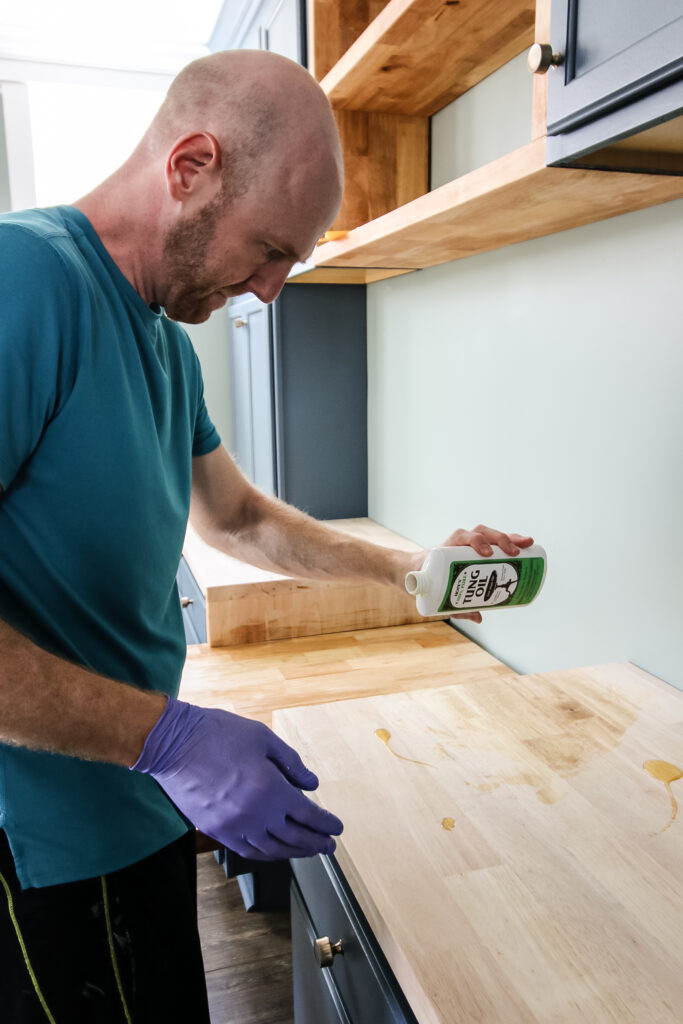 Pouring tung oil onto butcher block slab