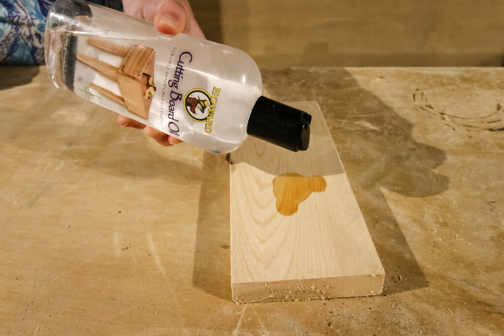 pouring mineral oil onto a board