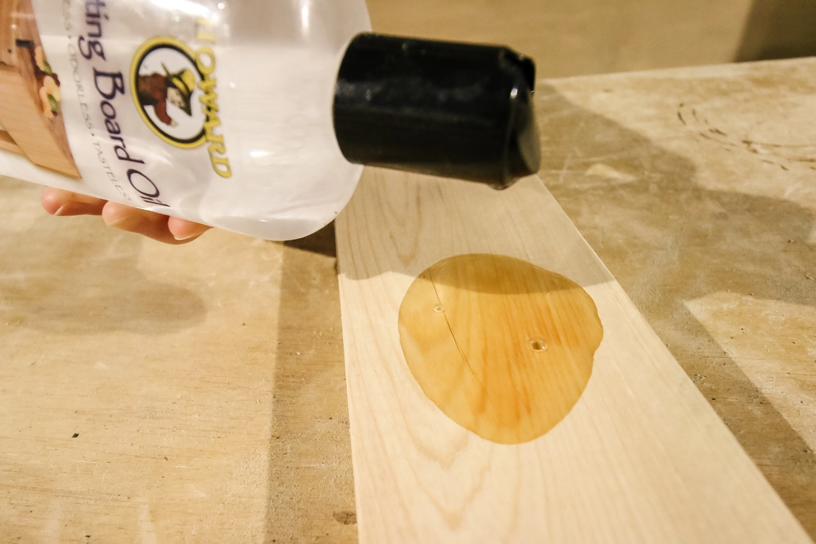 pouring mineral oil onto a board