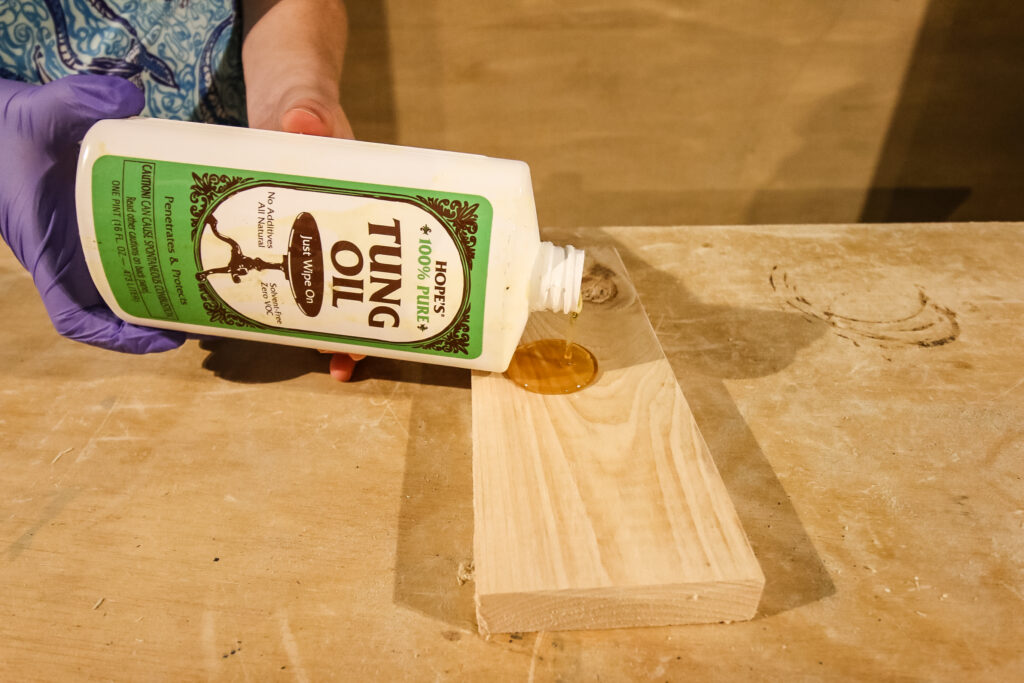 pouring tung oil on to a board