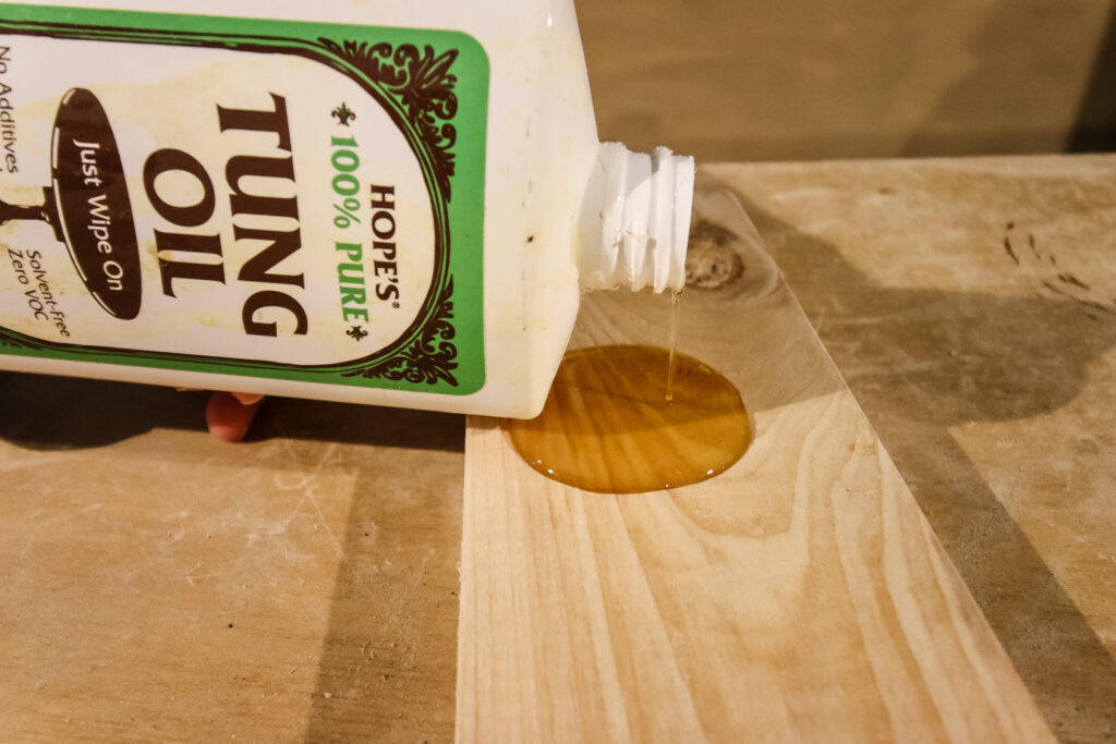 pouring tung oil on to a board