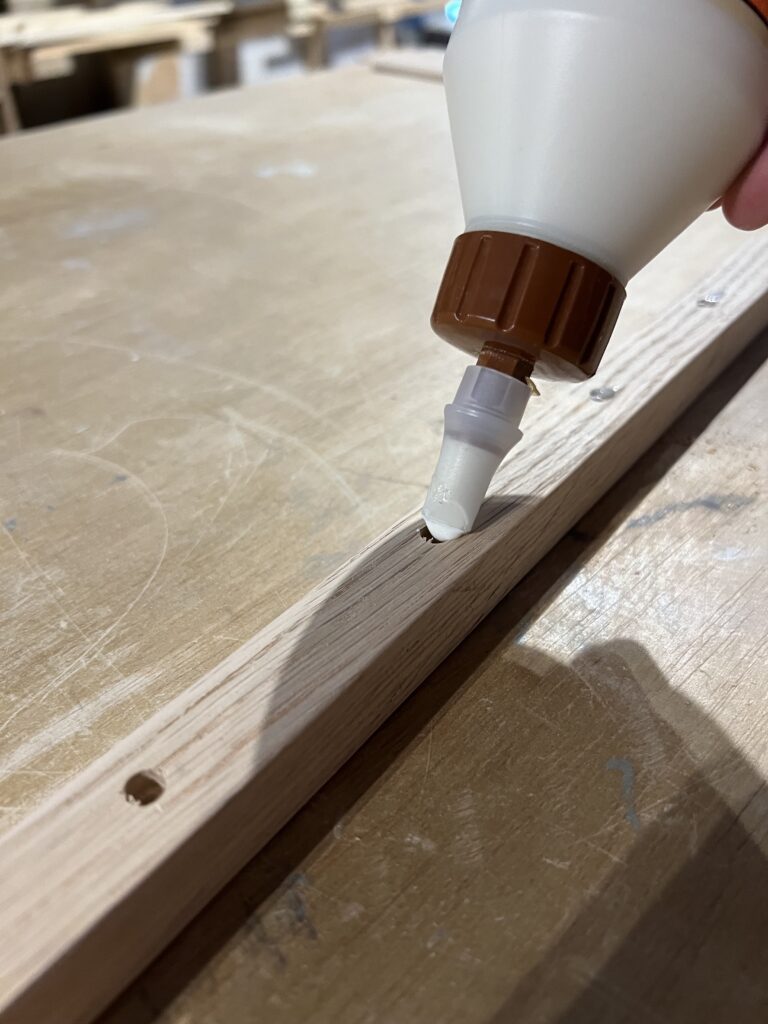 Adding glue to pilot holes