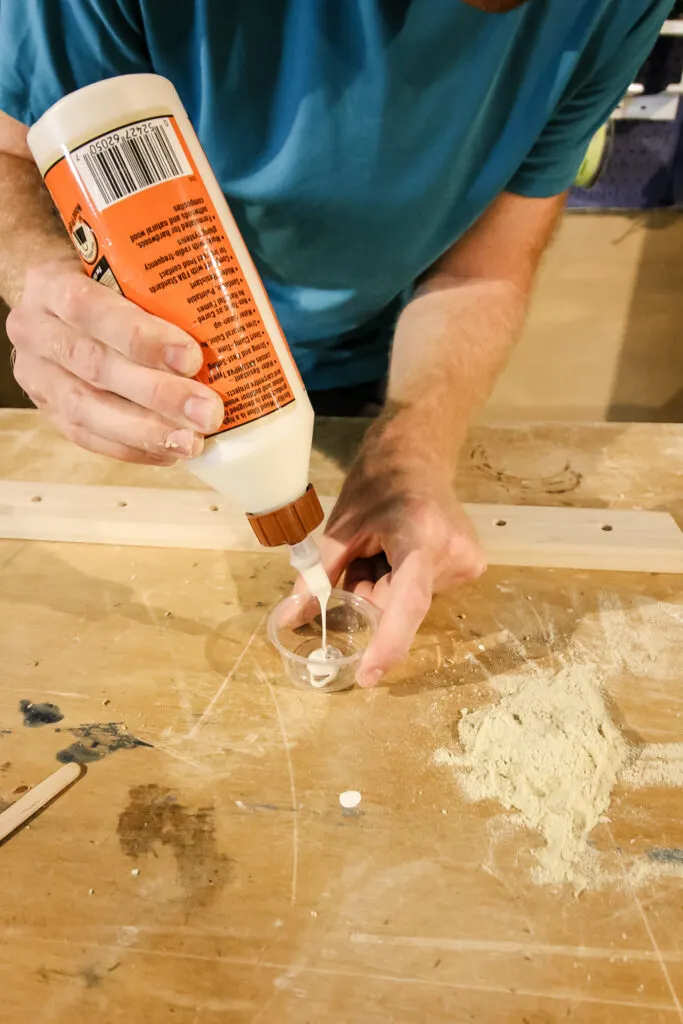 Putting wood glue binder into cup
