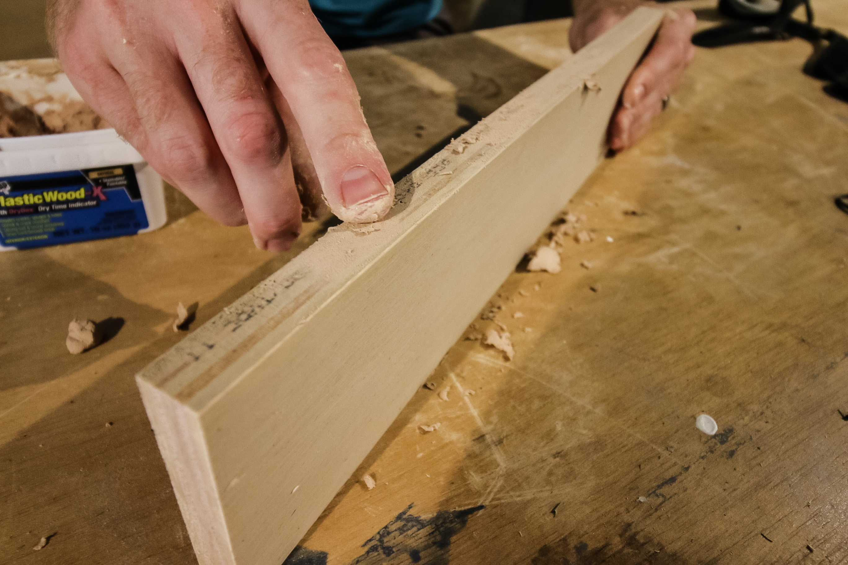 applying wood filler to a plywood edge