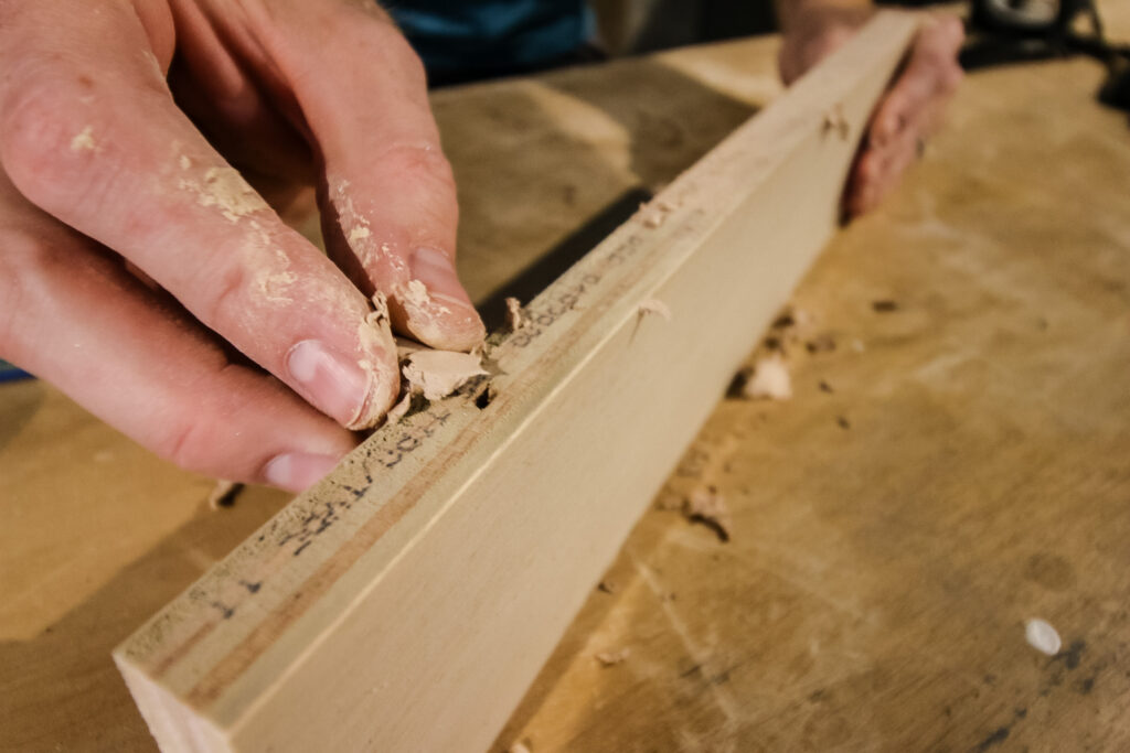 applying wood filler to a plywood edge