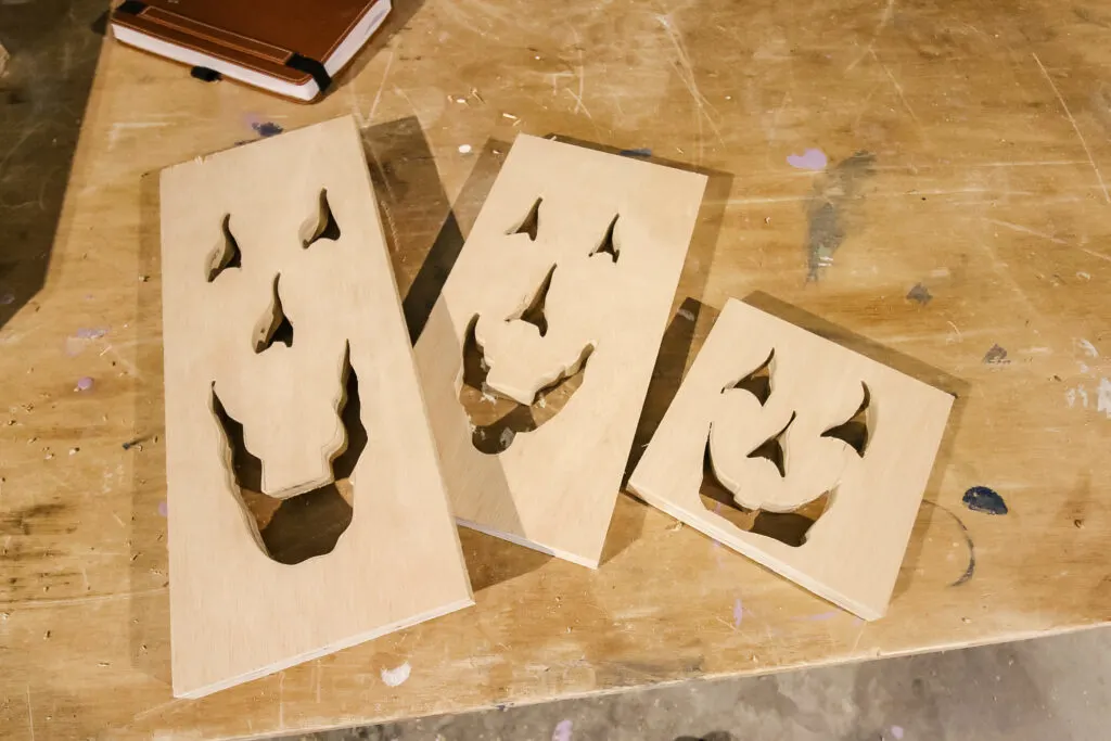 Jack o lantern faces cut out of wood