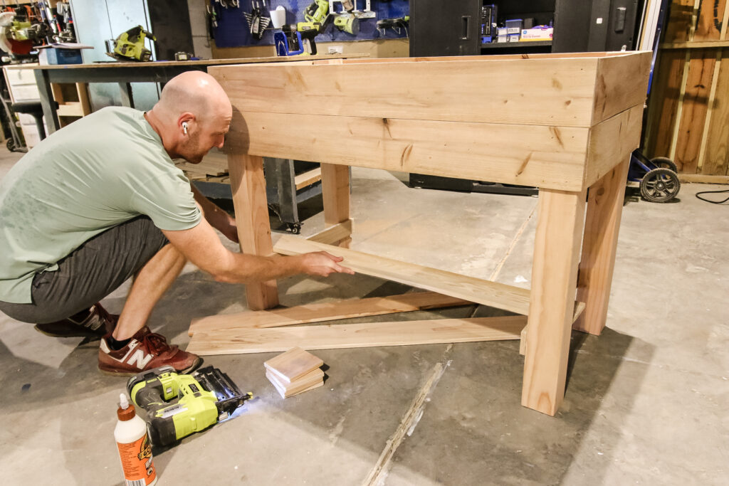 Using wood glue and nails to attach storage base