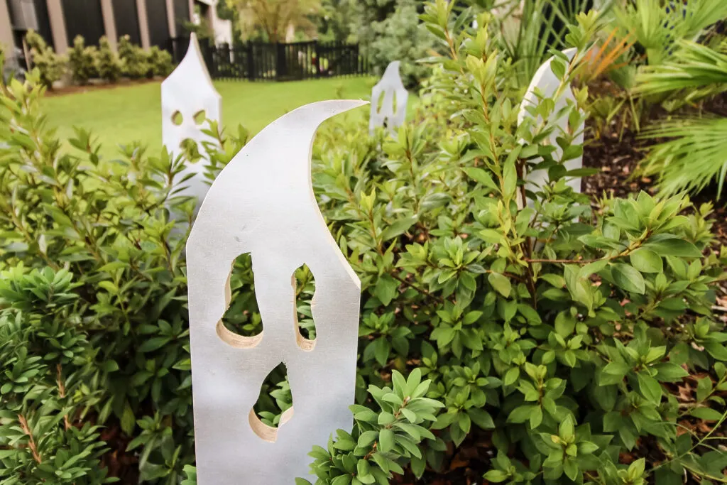 DIY wooden ghosts in bushes
