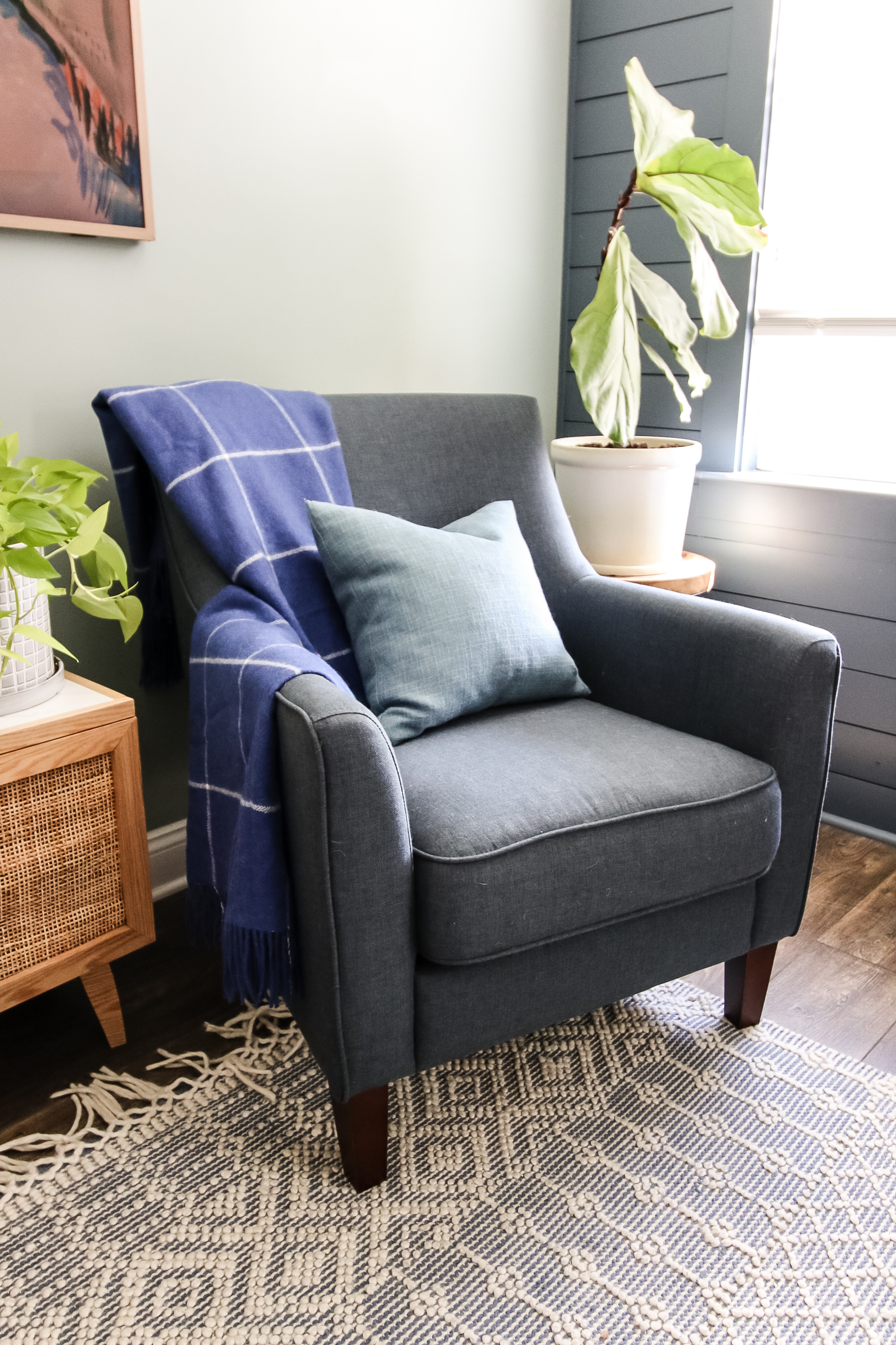 blanket folded on a chair with throw pillow