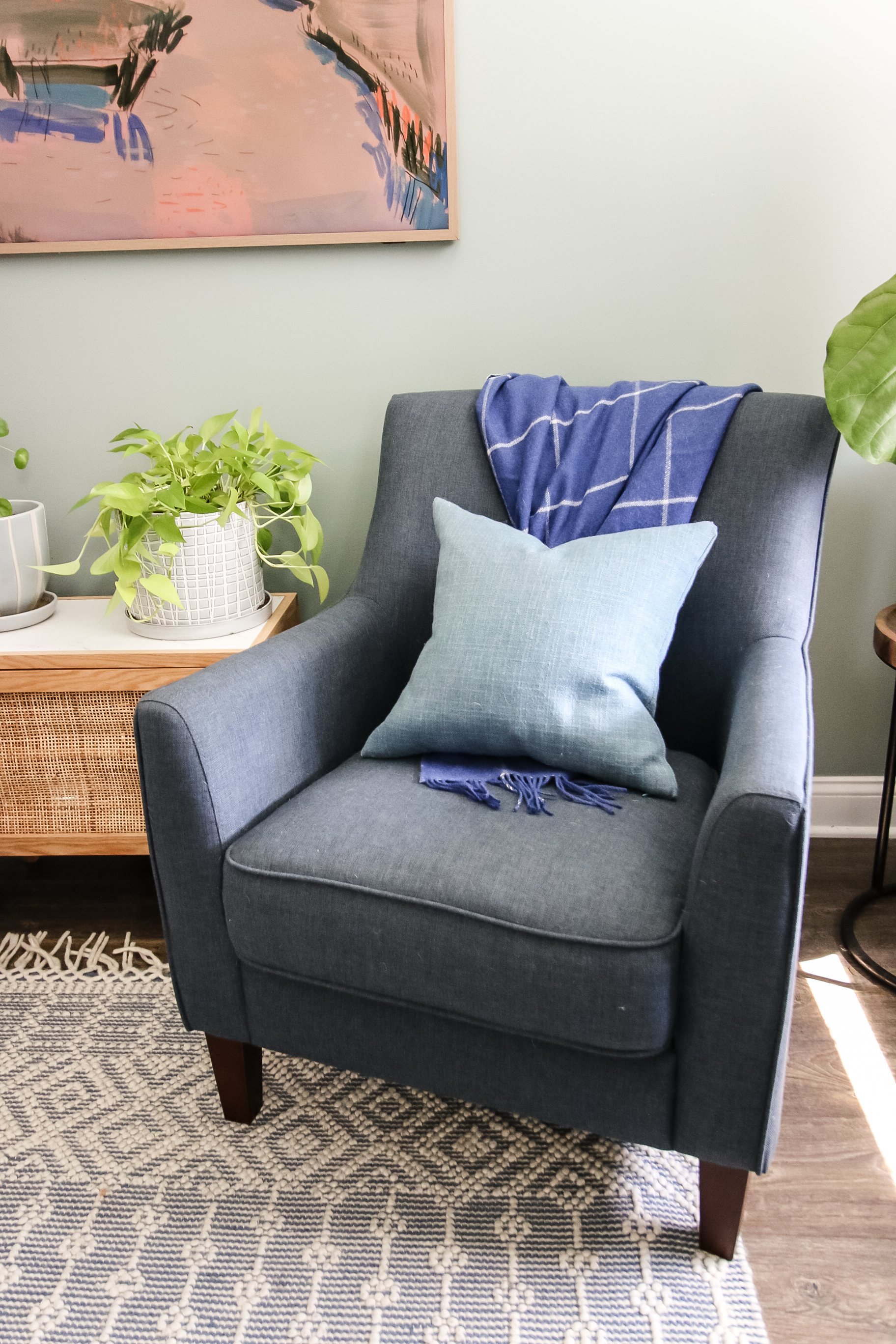 blanket folded on a chair with throw pillow