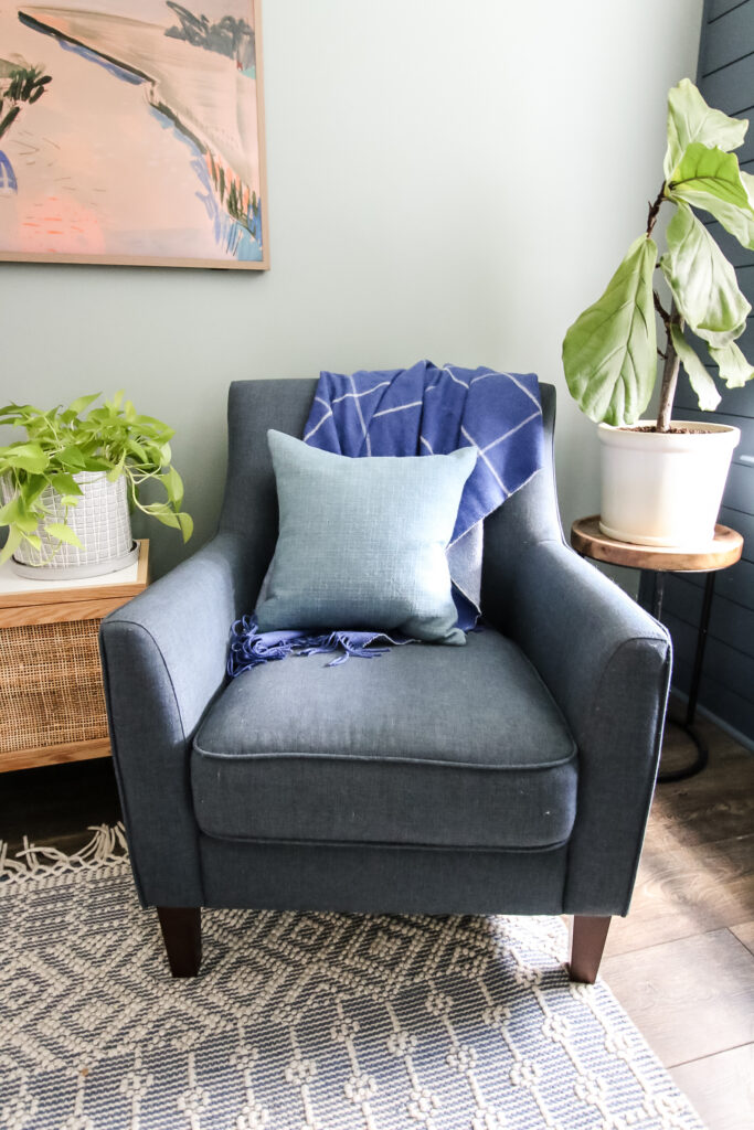 blanket folded on a chair with throw pillow