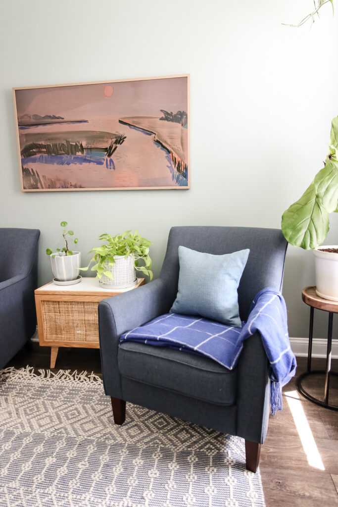 blanket folded on a chair with throw pillow