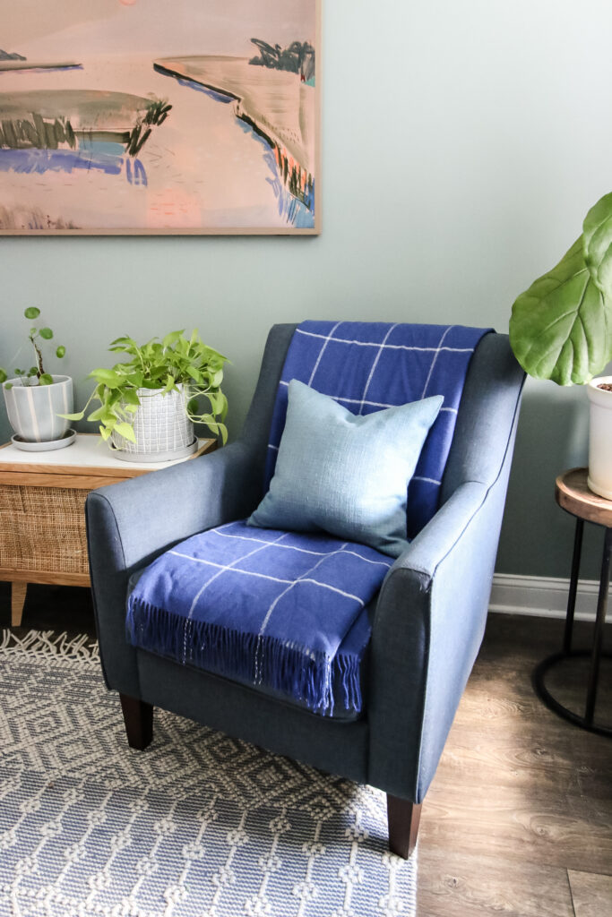 blanket folded on a chair with throw pillow