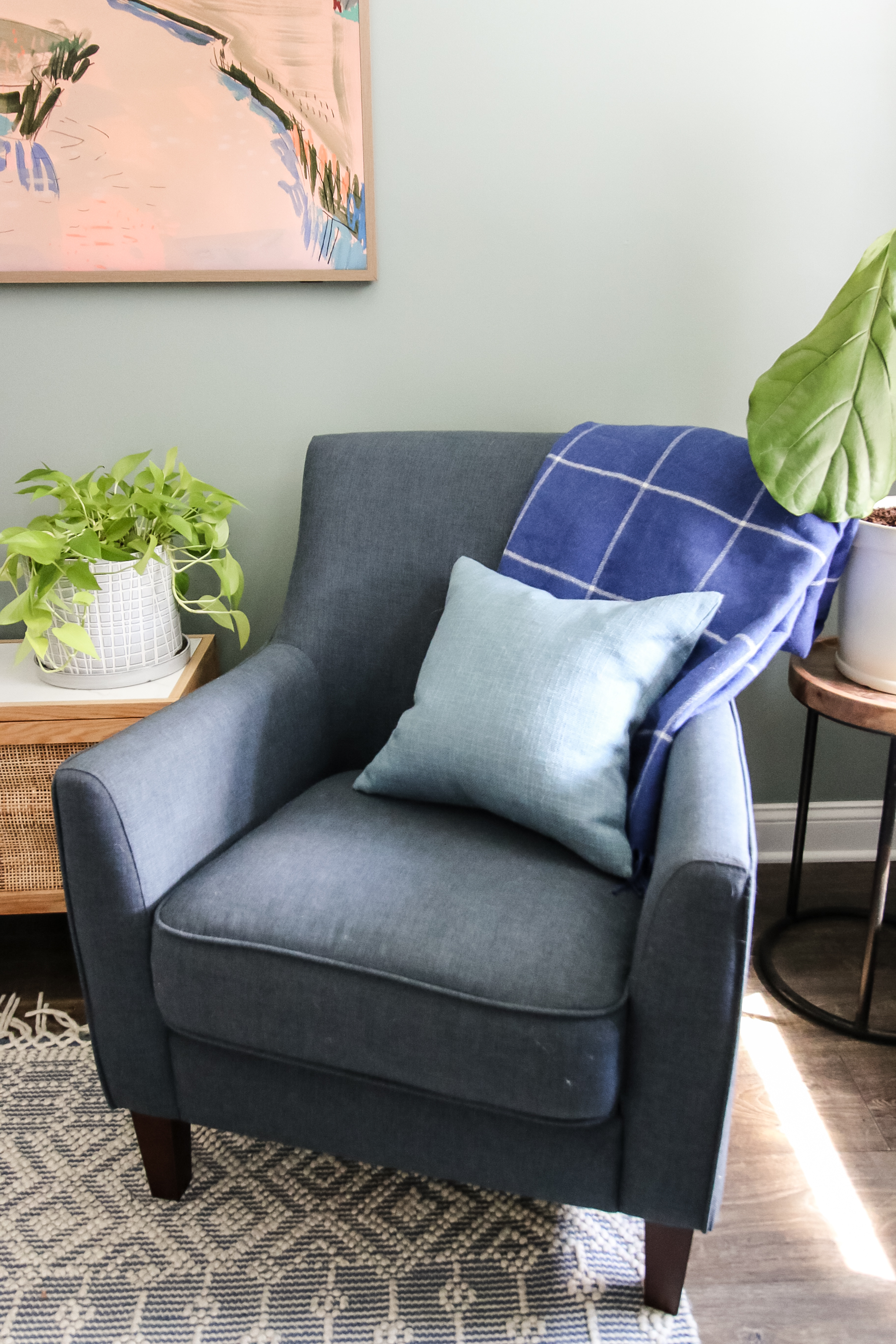 blanket folded on a chair with throw pillow