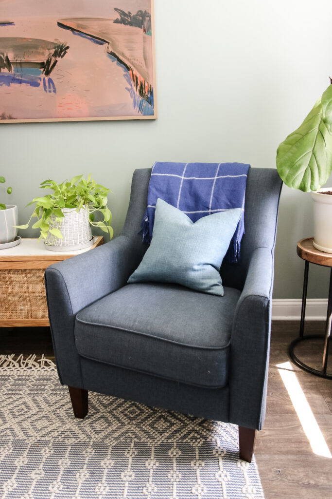 blanket folded on a chair with throw pillow