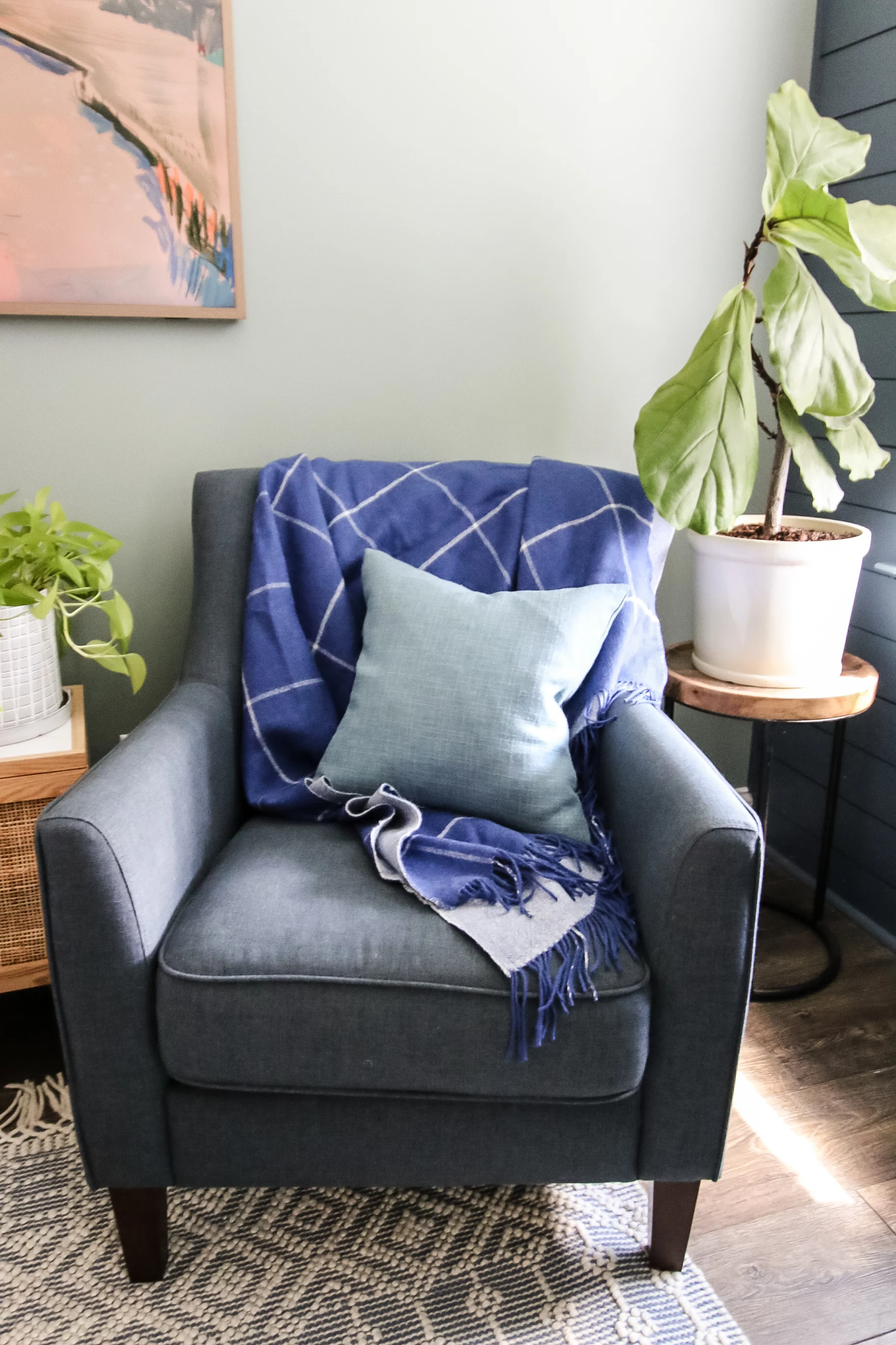 blanket folded on a chair with throw pillow