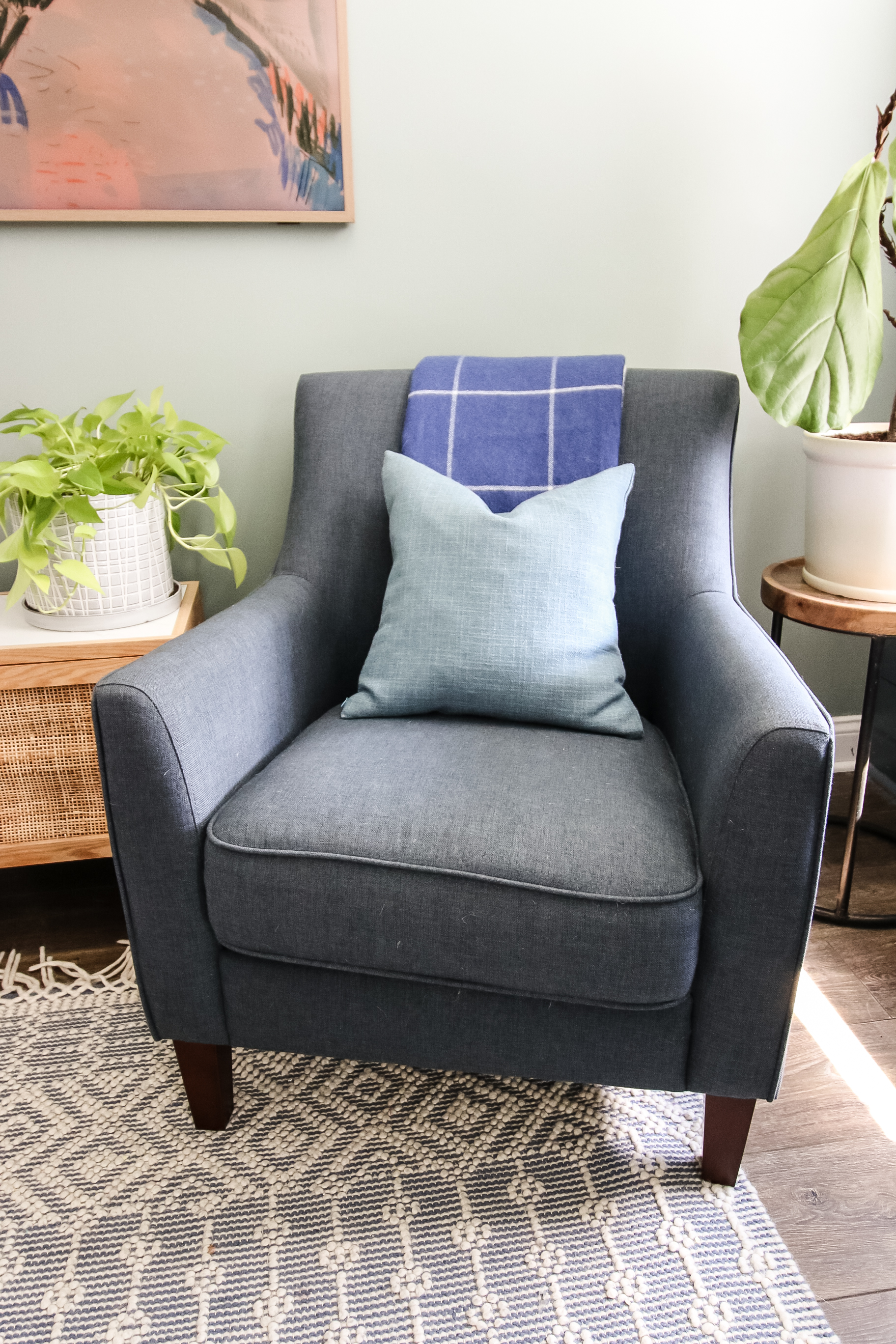 blanket folded on a chair with throw pillow