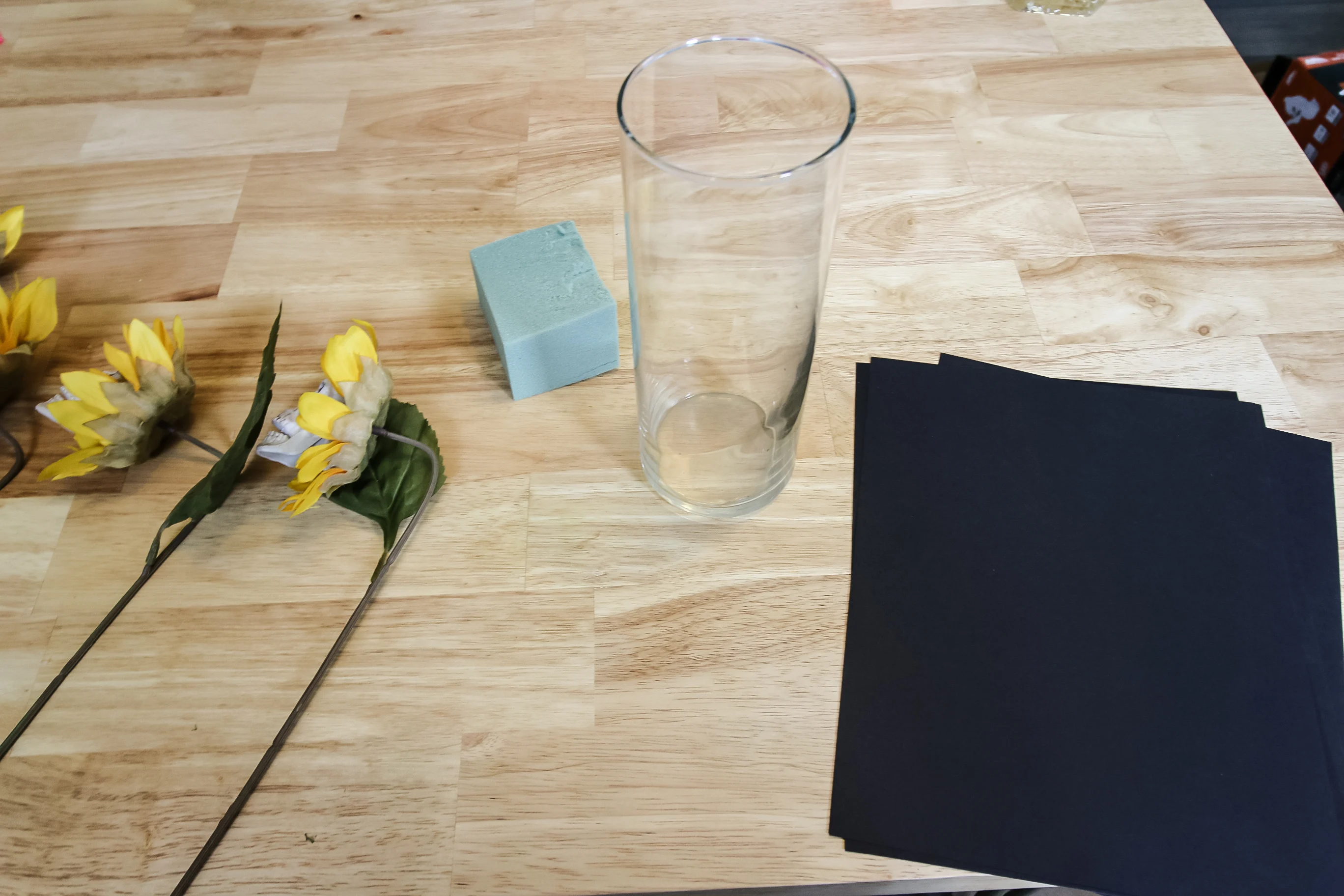 adding paper and foam to a glass vase