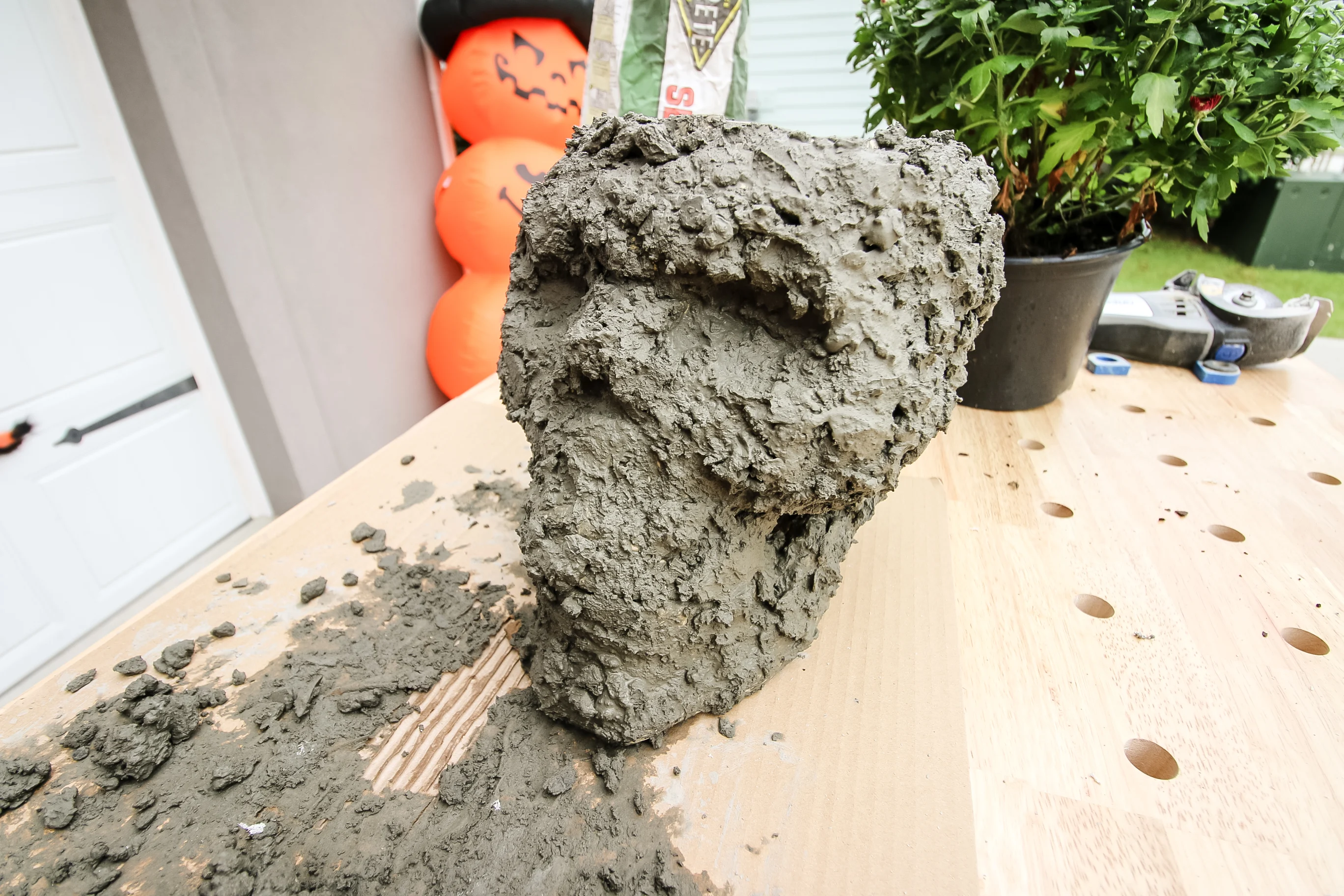 Concrete skull planter with rocky concrete