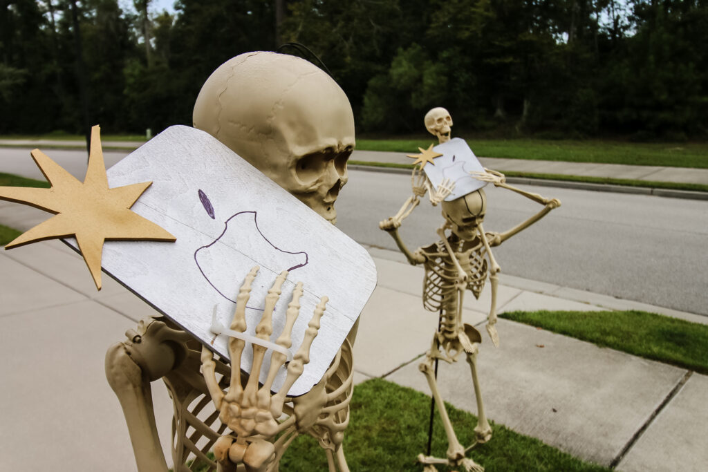 skeletons posed in the yard