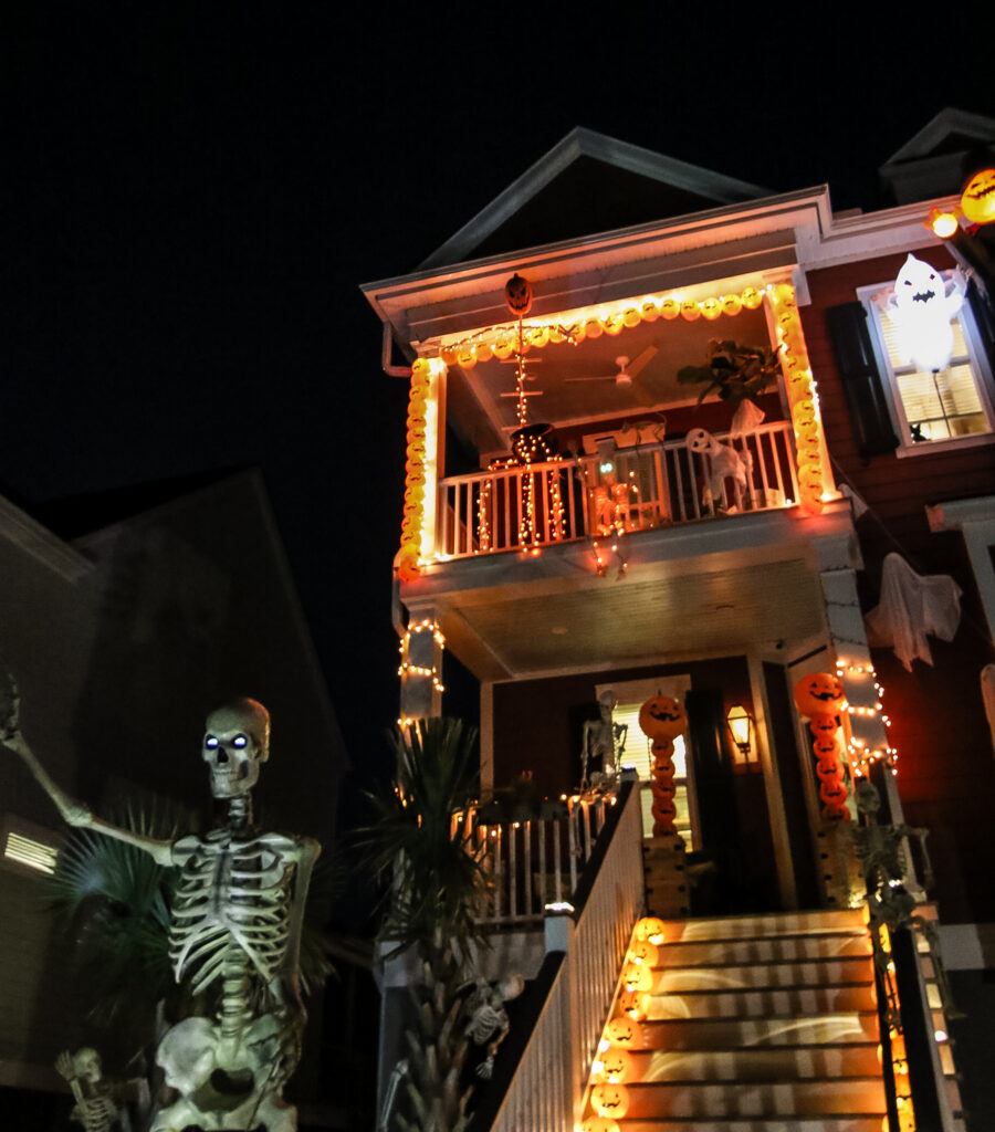 PVC skeleton with halloween decor at night
