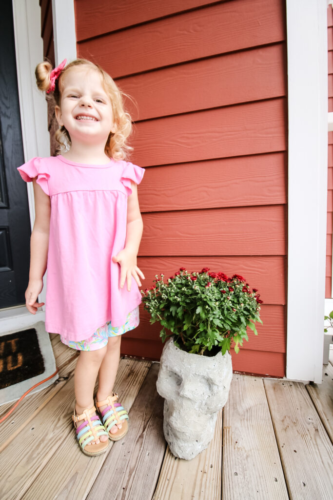 Girl with DIY concrete skull planter