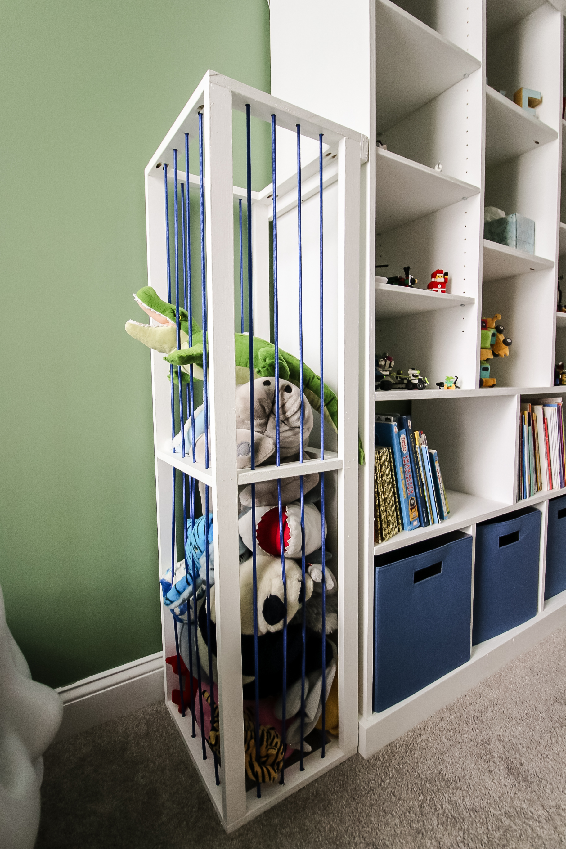 Stuffed animal zoo attached to bookcase