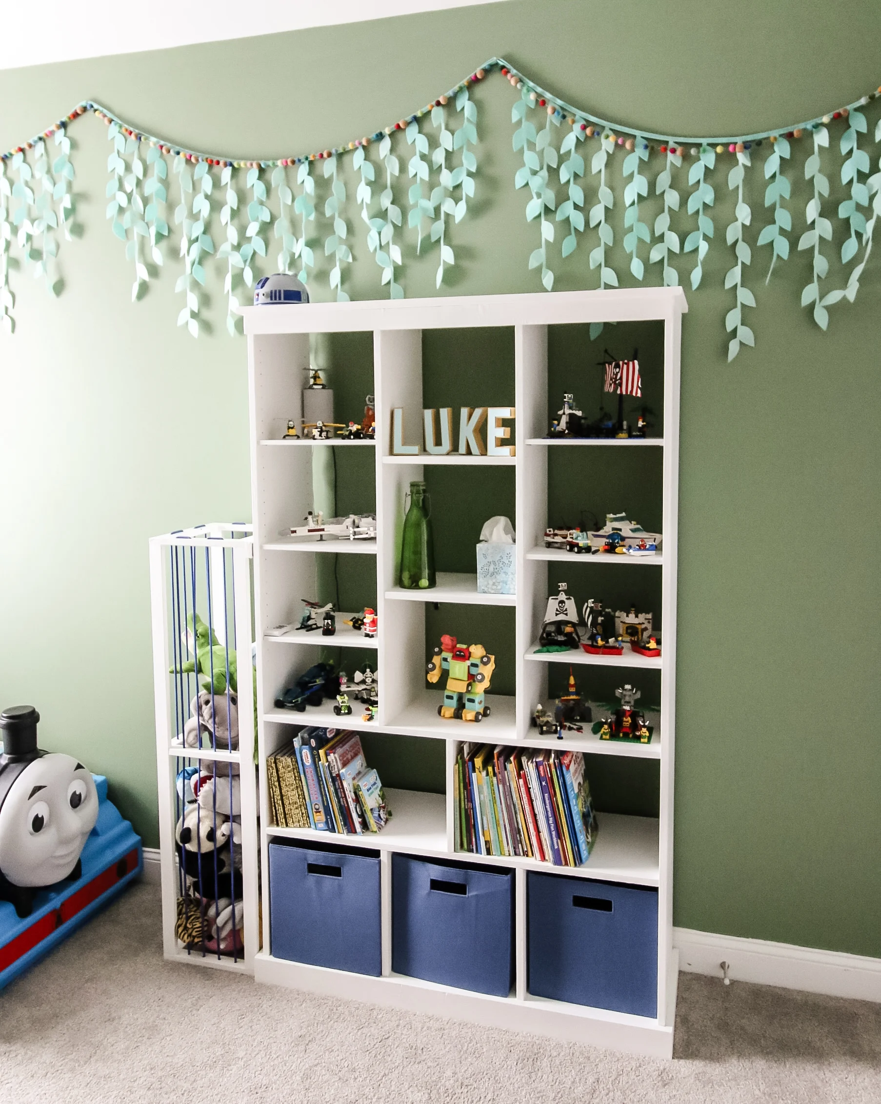 Straight view of DIY bookcase with toy storage and stuffed animal zoo