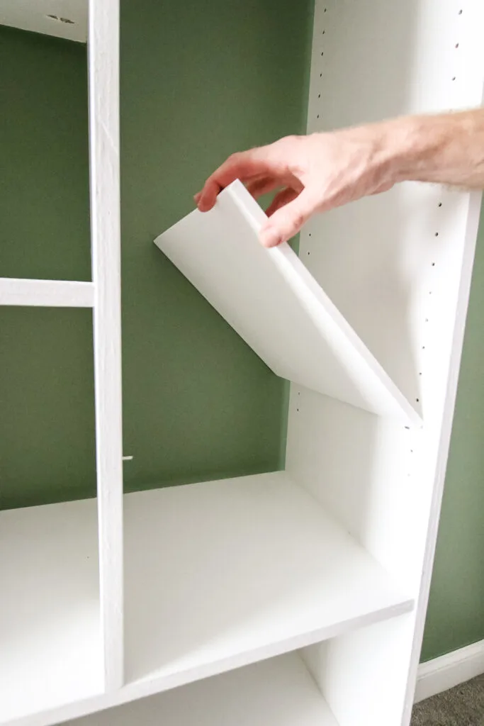 Inserting shelf on shelf pins