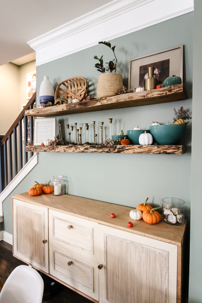 pumpkin fall decor on dining shelves
