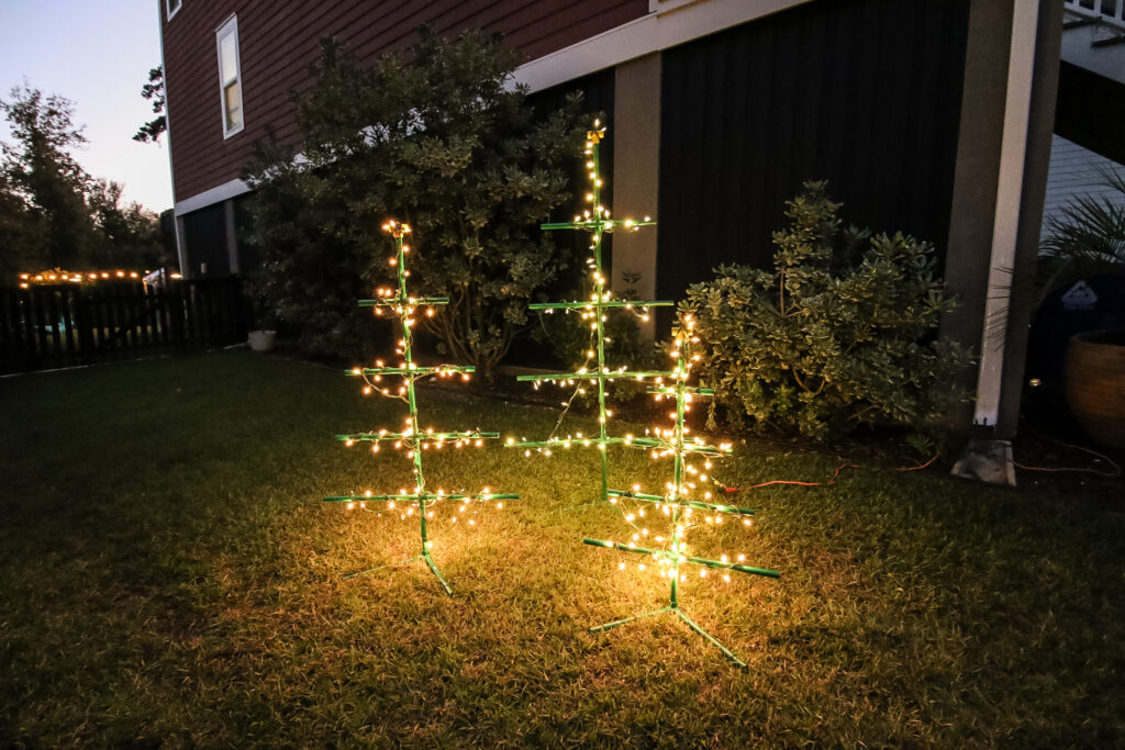 PVC pipe trees with lights in yard