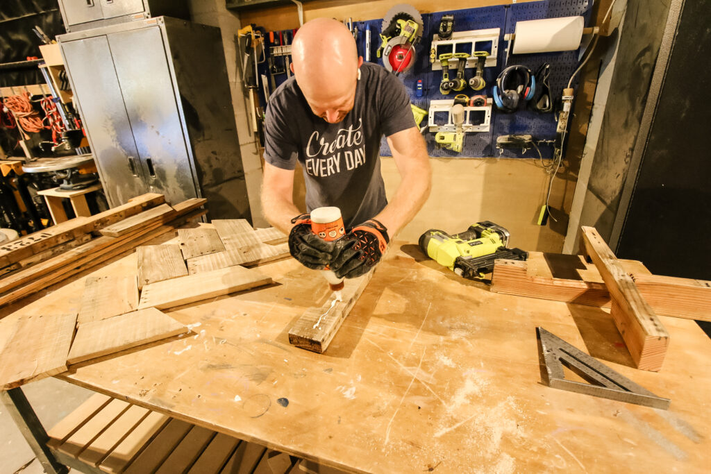 Applying wood glue to tree post