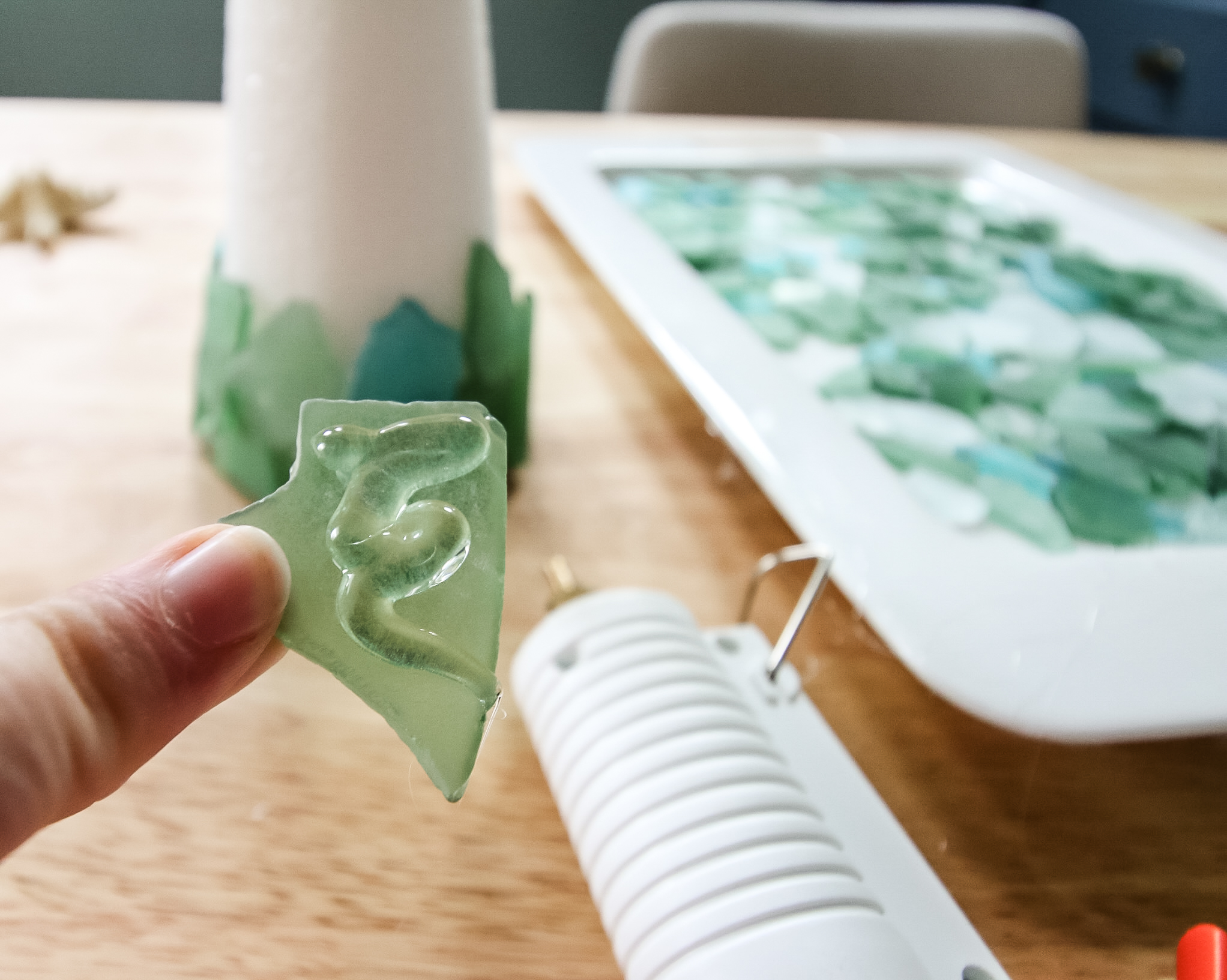 hot gluing glass to make a sea glass christmas tree