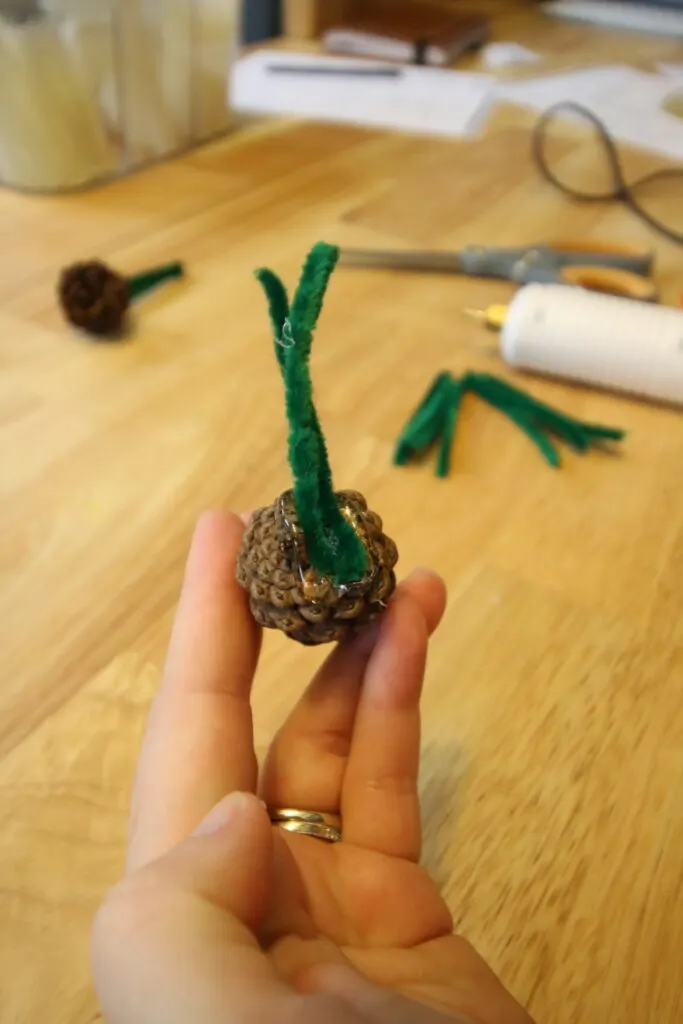 gluing wire to the bottom of pine cone