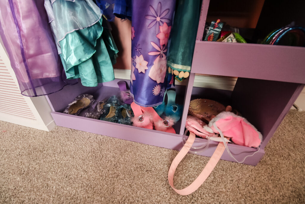 Shoe storage on bottom of dress up rack