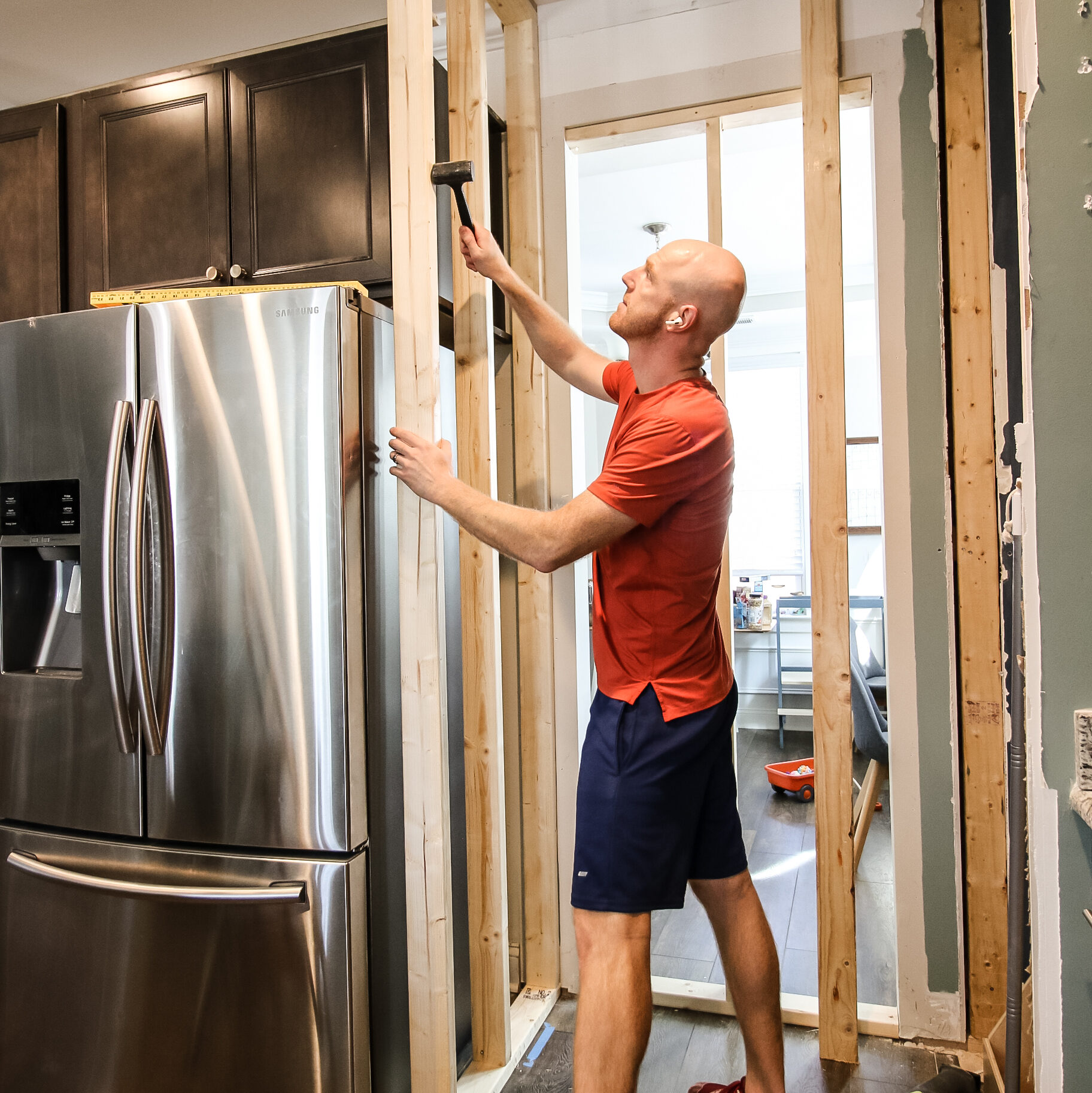Hammering walls into place for new pantry