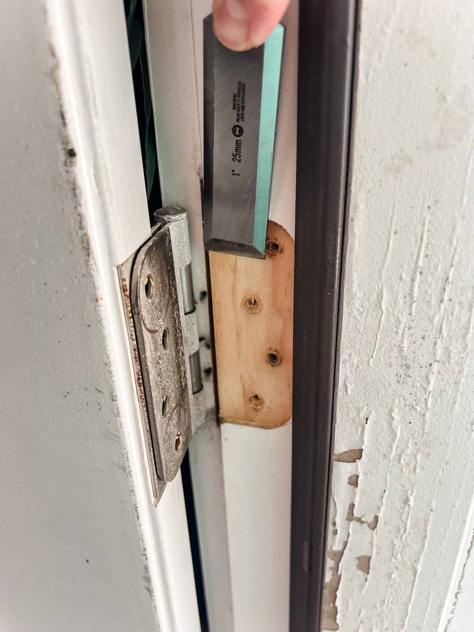 Using chisel to shave down hinge notch