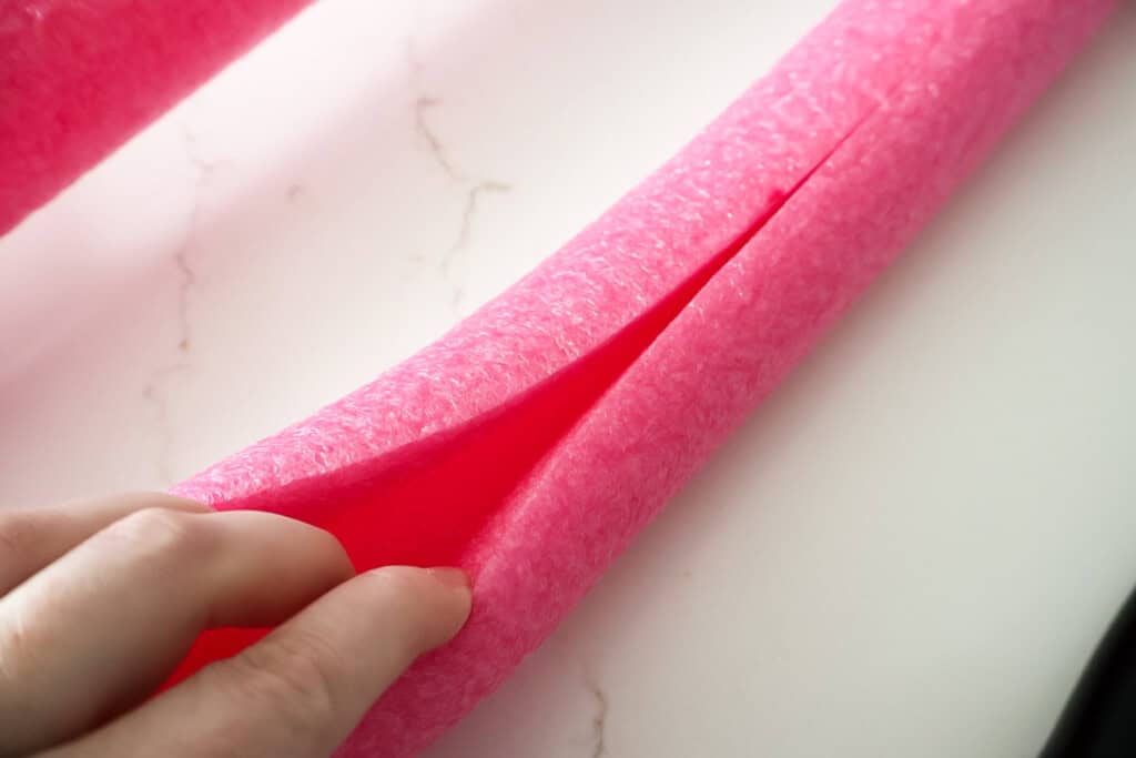 putting pool noodles on a hula hoop 
