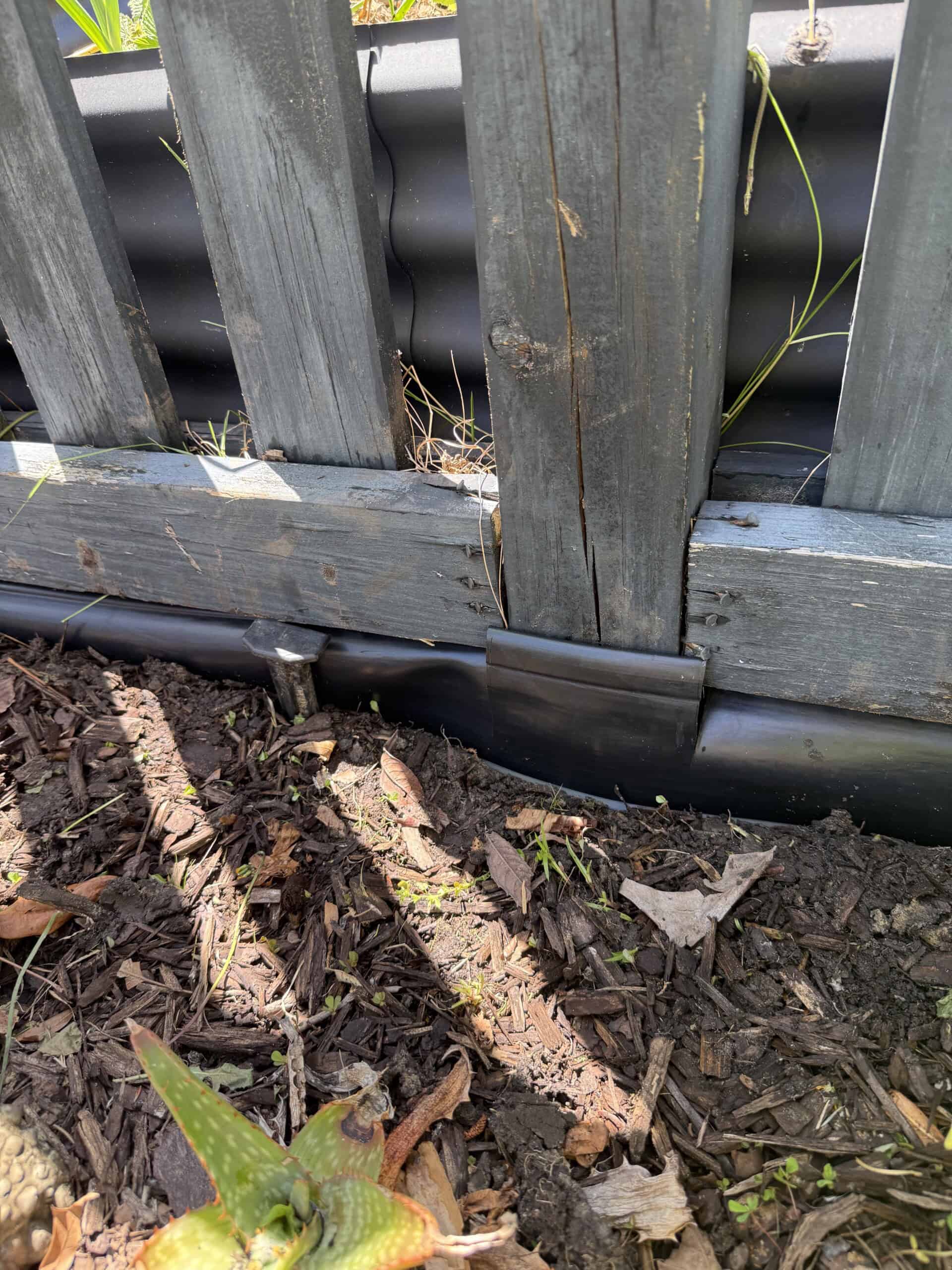 Cut edging at fence posts