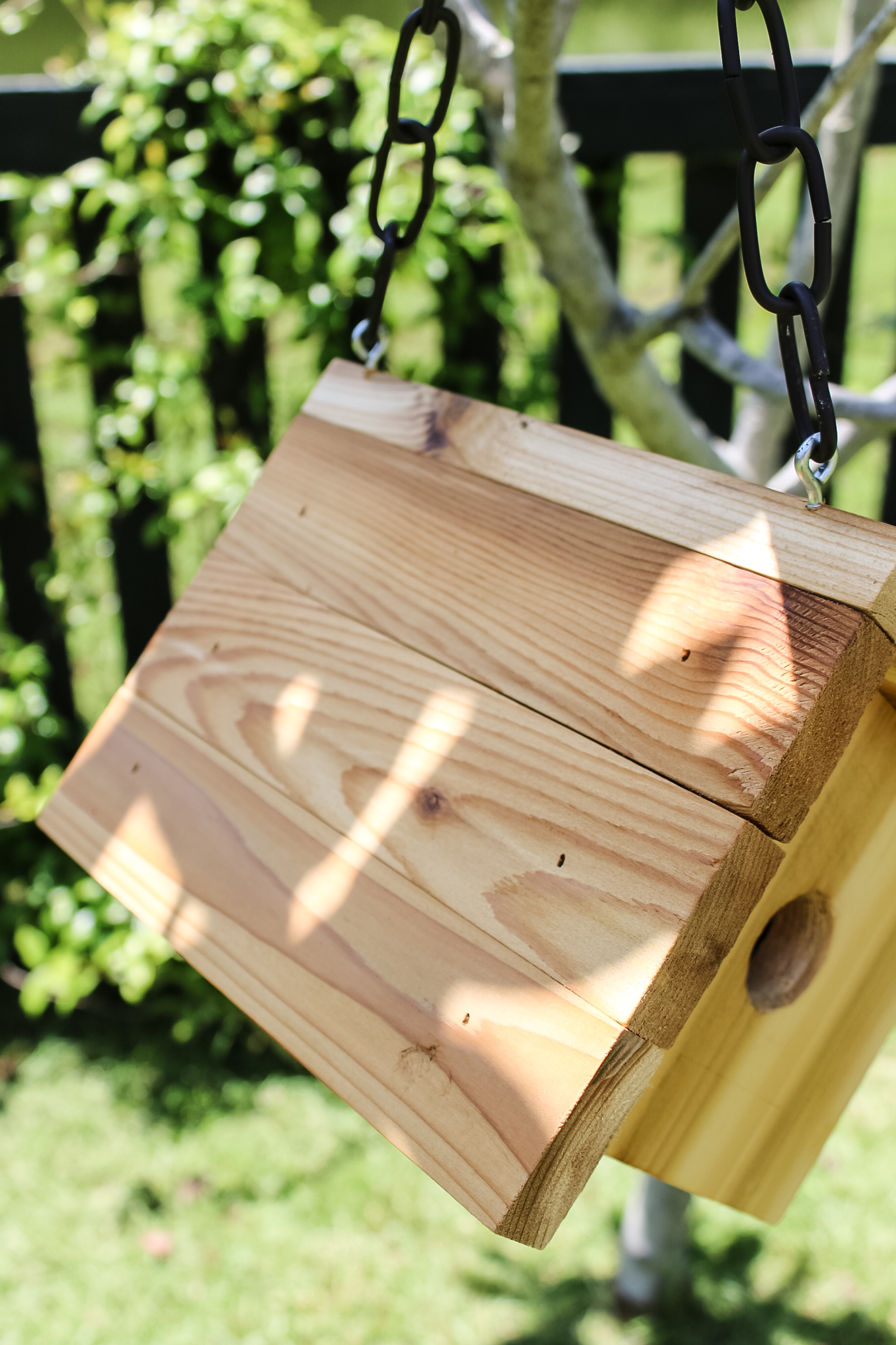 Hangers and chain on birdhouse