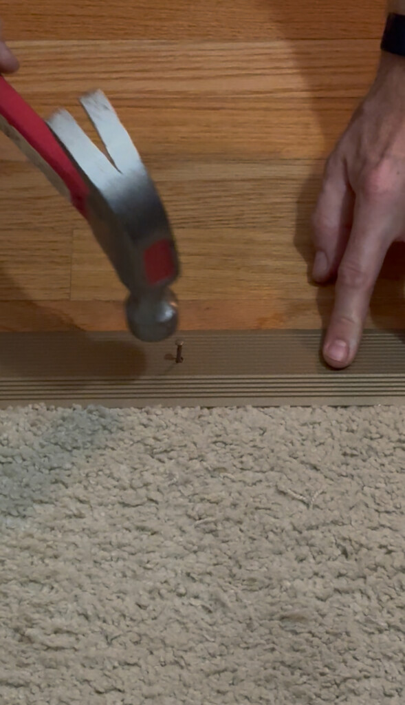 Hammering nails into transition strip