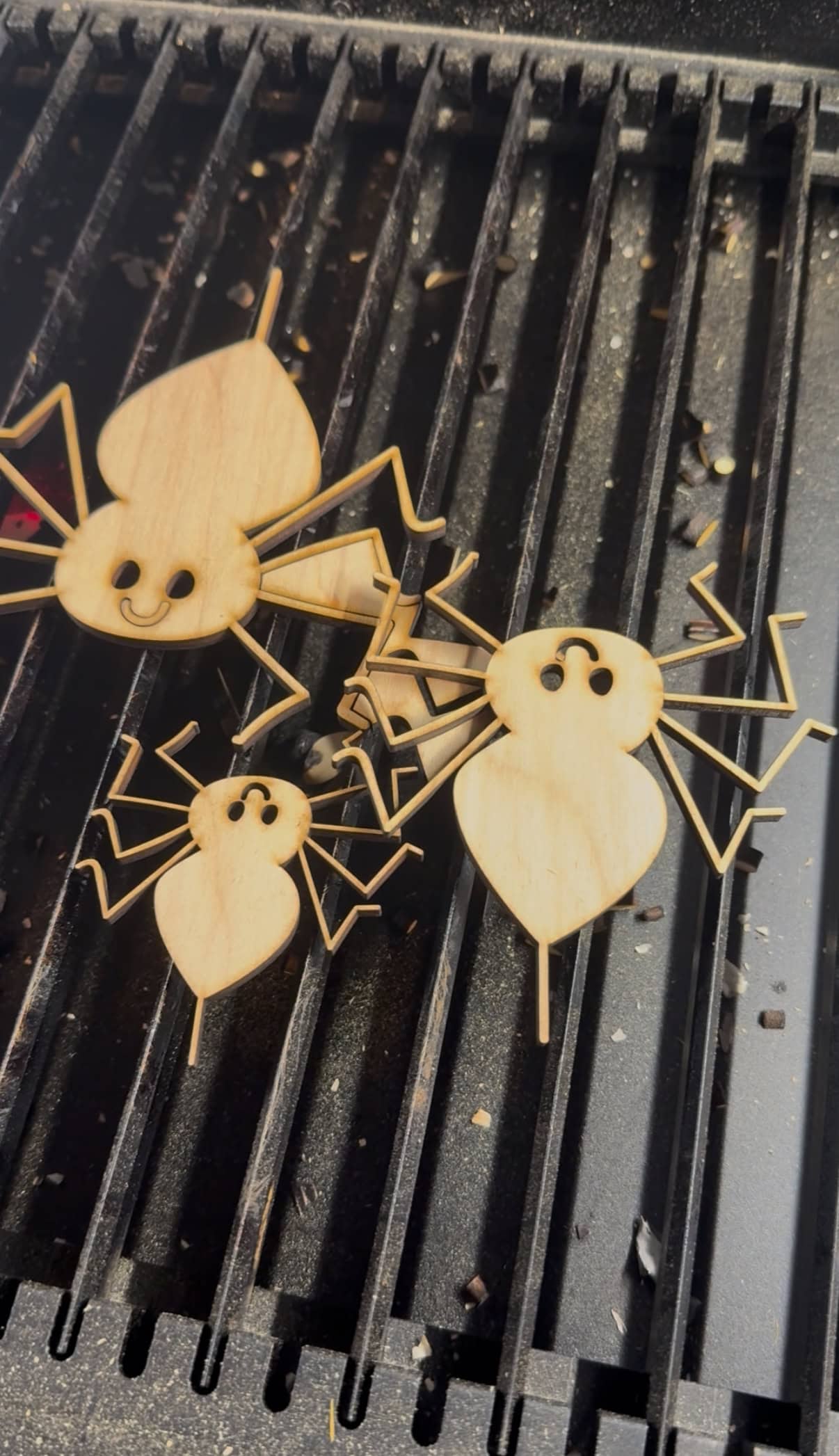 Cutting out wooden spiders on laser cutter